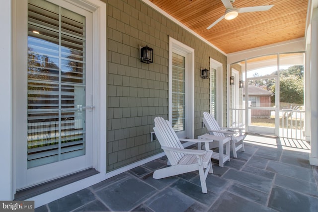 sunroom / solarium featuring ceiling fan and wooden ceiling