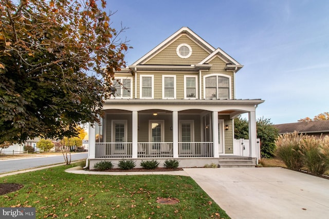 view of front of property with a porch and a front lawn