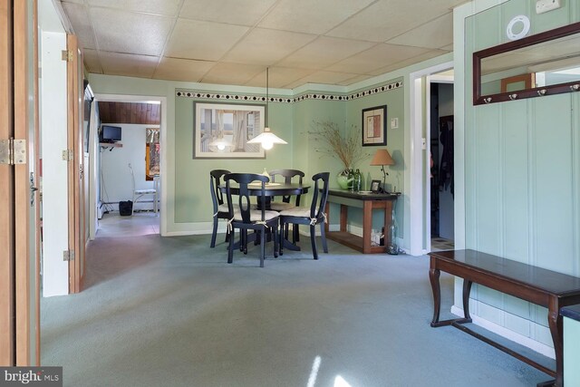 dining area featuring a drop ceiling