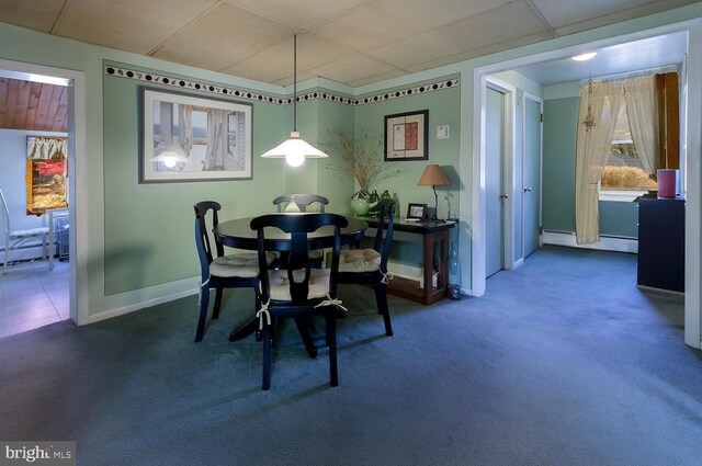 dining area with dark colored carpet and a baseboard radiator