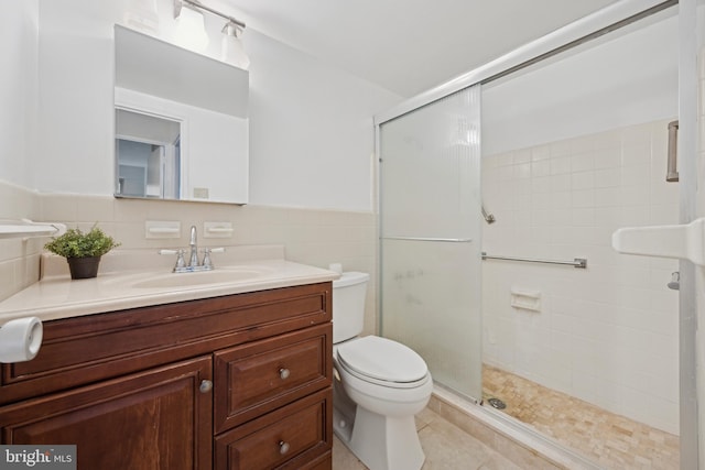 bathroom featuring tile patterned floors, toilet, tile walls, and walk in shower