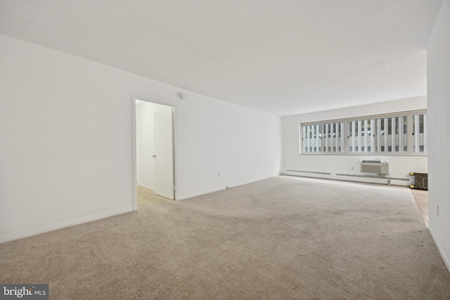 empty room with light colored carpet and a baseboard heating unit