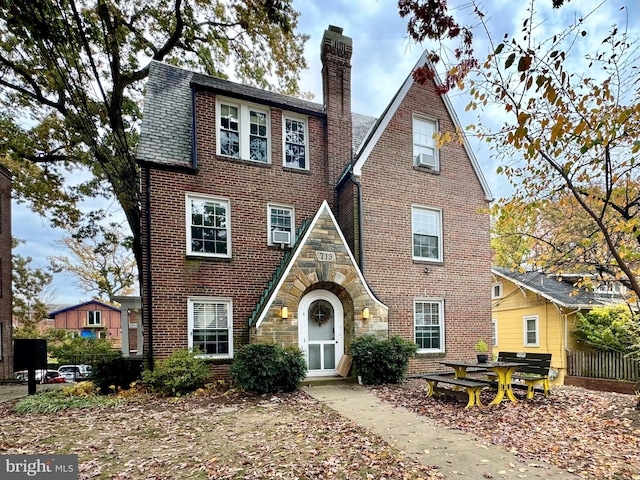 tudor home featuring cooling unit