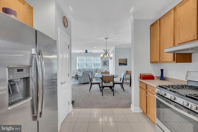 kitchen with stainless steel appliances, hanging light fixtures, light tile patterned floors, a chandelier, and crown molding