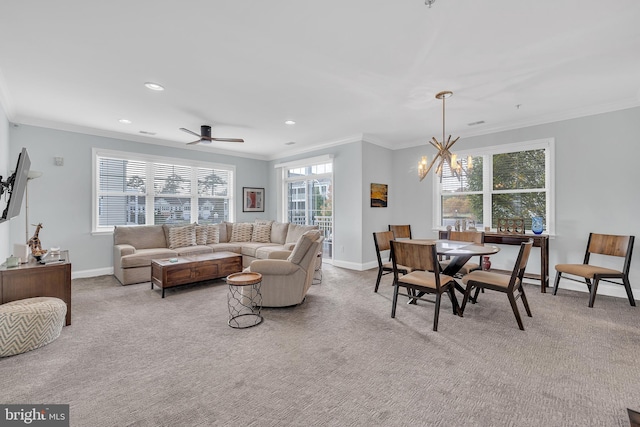 living room featuring light carpet, a healthy amount of sunlight, crown molding, and ceiling fan