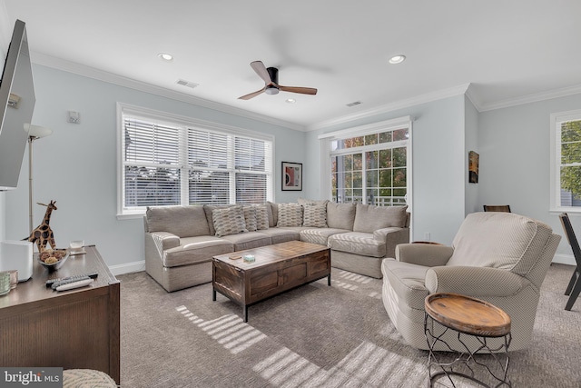 living room featuring ceiling fan, crown molding, and light colored carpet