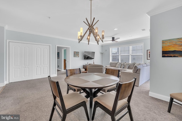 carpeted dining area featuring ornamental molding and ceiling fan