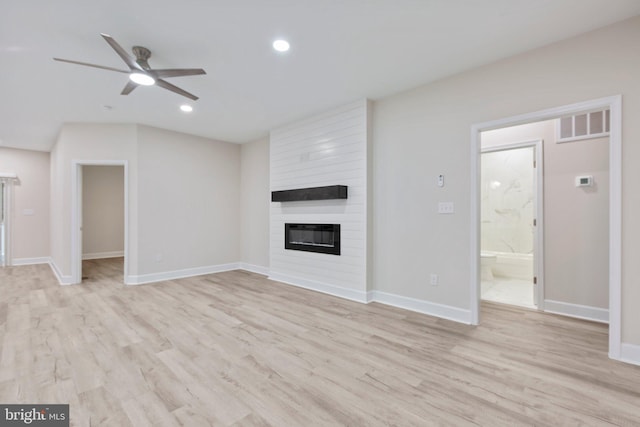 unfurnished living room featuring light wood-type flooring, a fireplace, and ceiling fan