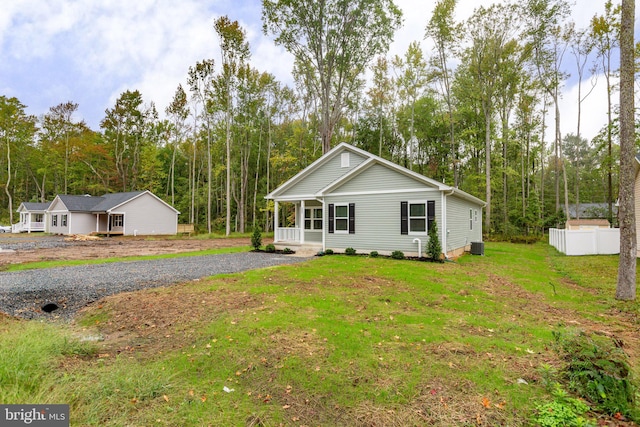 ranch-style house featuring a front yard and covered porch