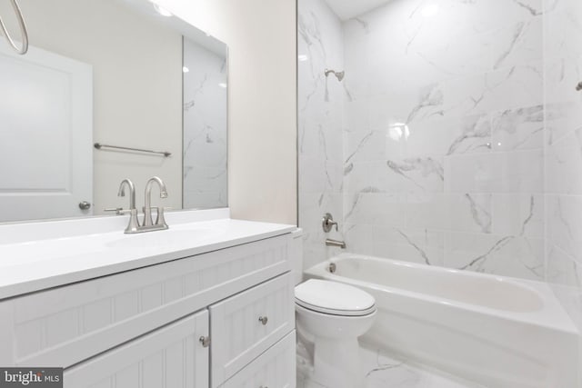 full bathroom featuring toilet, tiled shower / bath combo, and vanity