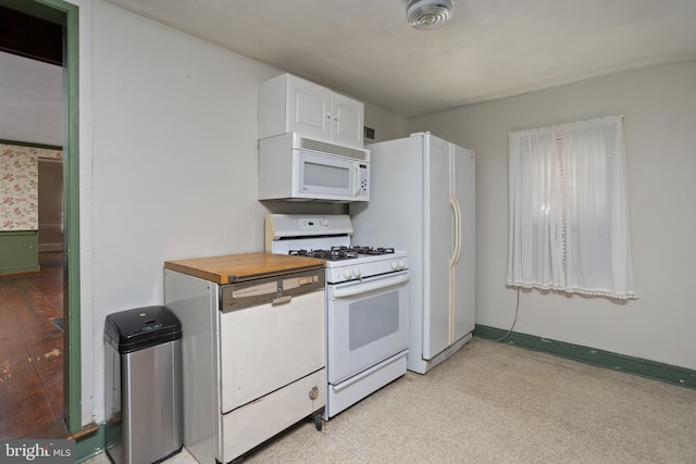 kitchen with white cabinetry, white appliances, and wood counters