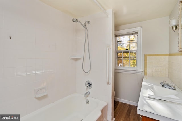 bathroom with tiled shower / bath, vanity, and hardwood / wood-style flooring