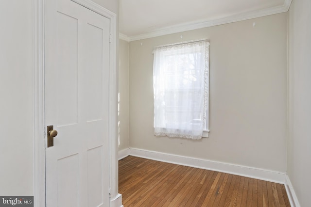 spare room with hardwood / wood-style floors and ornamental molding