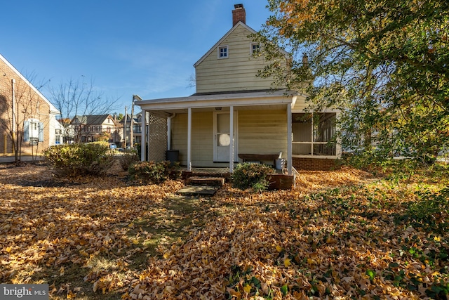 back of property with covered porch