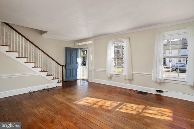 foyer entrance featuring dark hardwood / wood-style floors and ornamental molding