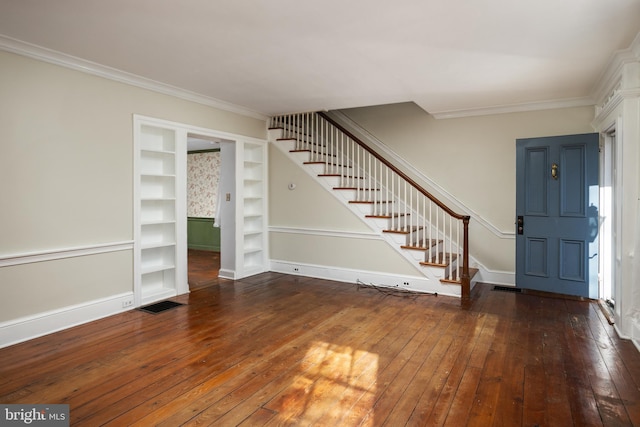 foyer entrance featuring ornamental molding and dark wood-type flooring