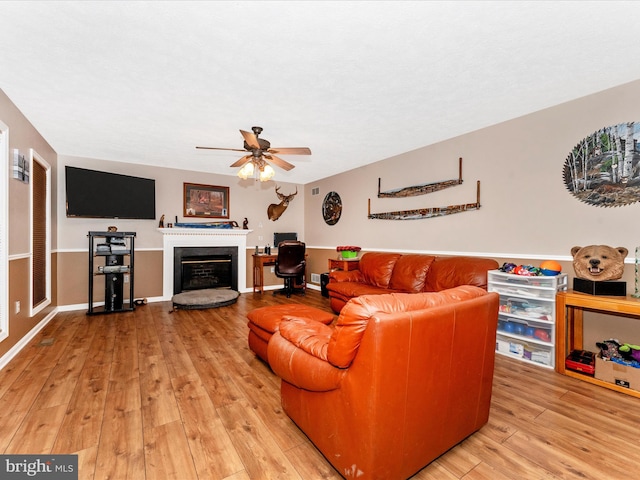 living room with ceiling fan and light hardwood / wood-style floors