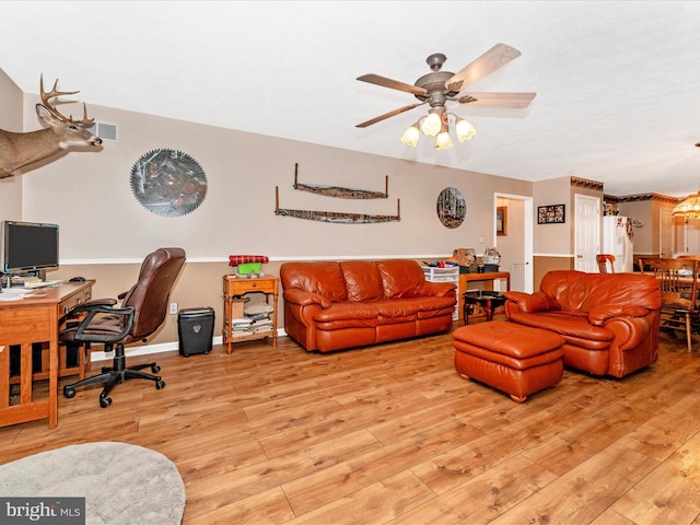 living room with ceiling fan and light hardwood / wood-style flooring