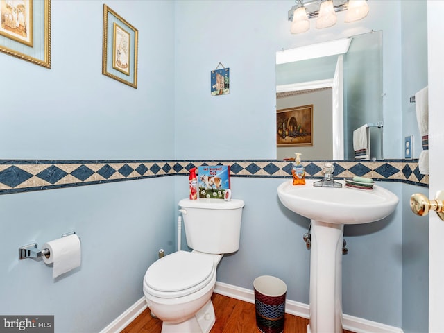 bathroom featuring toilet, tile walls, and wood-type flooring