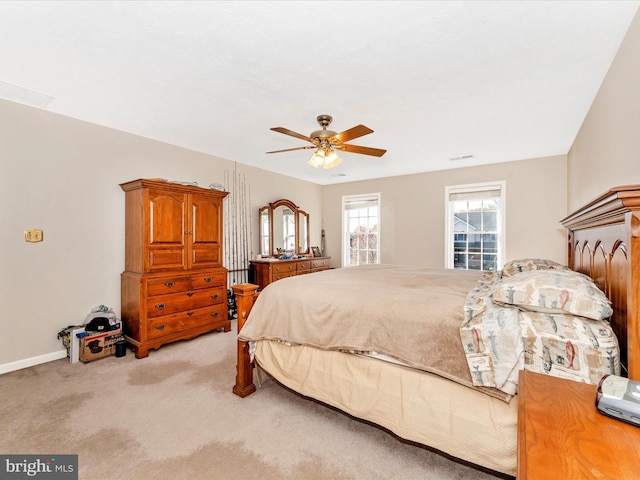 bedroom featuring light colored carpet and ceiling fan