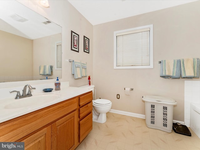 bathroom with toilet and vanity