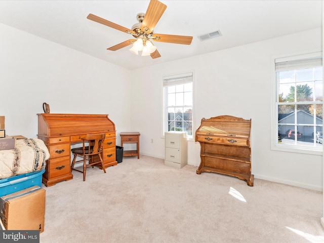 carpeted bedroom with multiple windows and ceiling fan