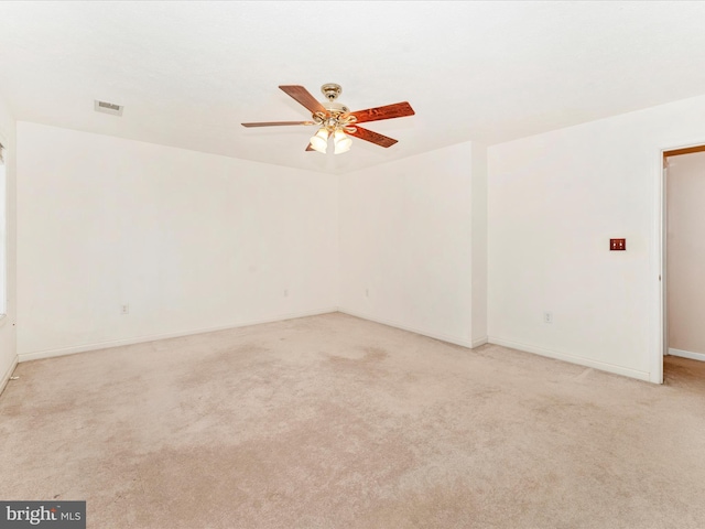 spare room with light carpet and ceiling fan