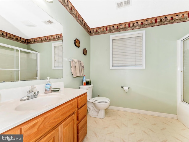 full bathroom with enclosed tub / shower combo, vanity, and toilet