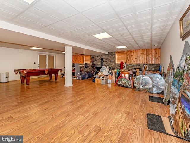 interior space with pool table, light hardwood / wood-style flooring, and a wood stove