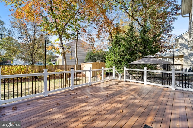 wooden terrace with a storage shed