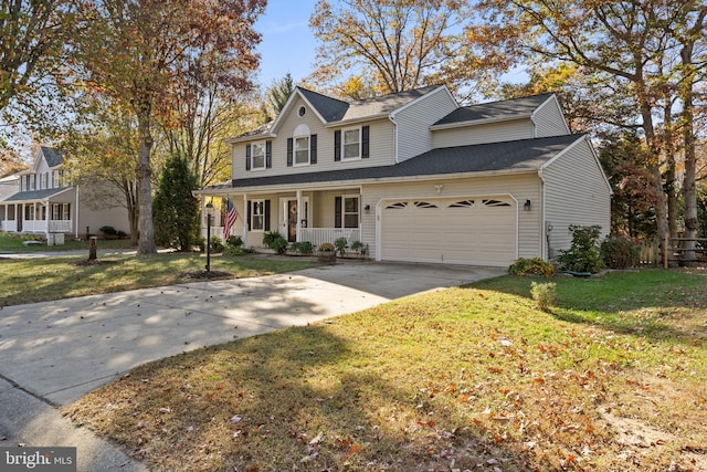 view of front of house featuring a front lawn, covered porch, and a garage