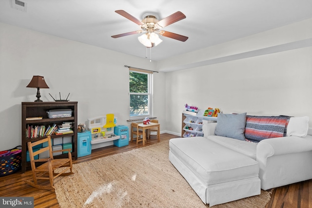 interior space with ceiling fan and wood-type flooring