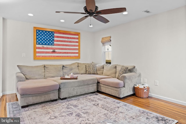 living room with ceiling fan and wood-type flooring