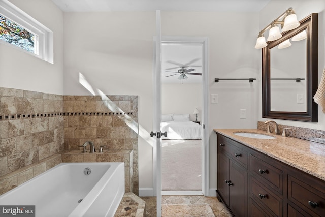 bathroom featuring vanity, tile patterned floors, ceiling fan, a washtub, and tile walls