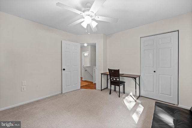 home office featuring ceiling fan and light carpet