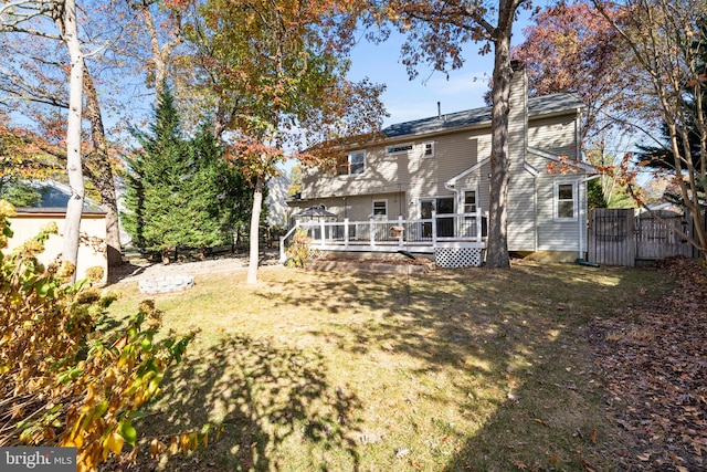 rear view of house with a lawn and a deck