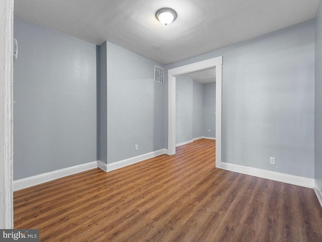 spare room featuring dark hardwood / wood-style flooring