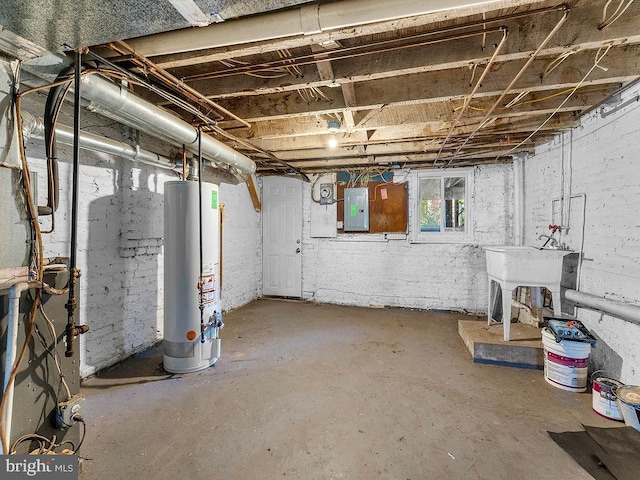 basement featuring sink, water heater, and electric panel