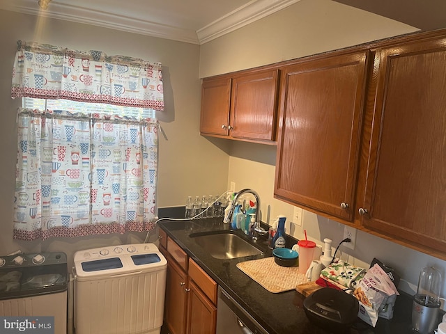 kitchen featuring a sink, brown cabinetry, ornamental molding, and washer / dryer