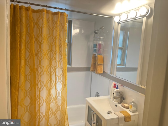 bathroom featuring vanity and shower / bath combination with curtain