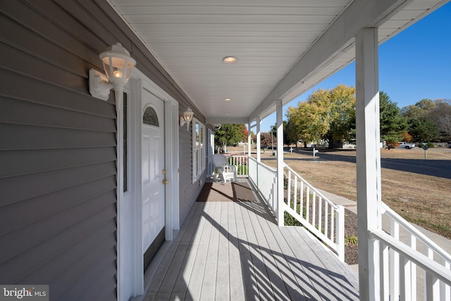 wooden terrace featuring covered porch