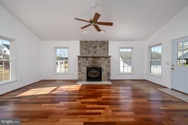 unfurnished living room with a fireplace, plenty of natural light, lofted ceiling, and dark hardwood / wood-style floors