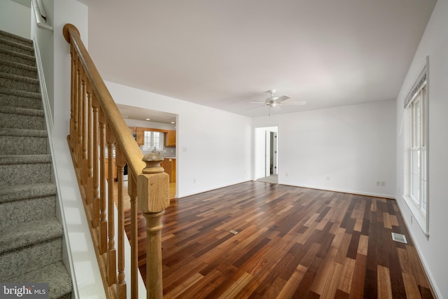 unfurnished living room with hardwood / wood-style flooring and ceiling fan