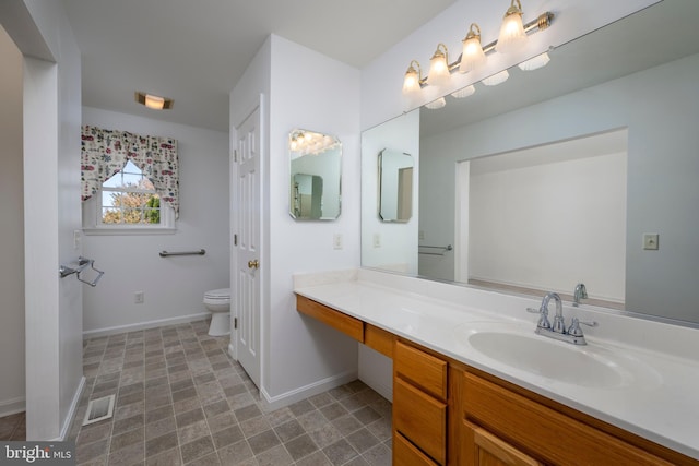 bathroom with vanity and toilet