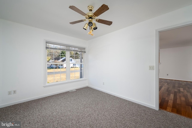 carpeted spare room featuring ceiling fan