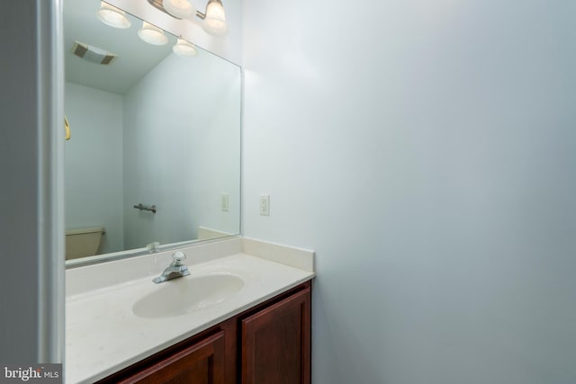 bathroom featuring toilet and vanity