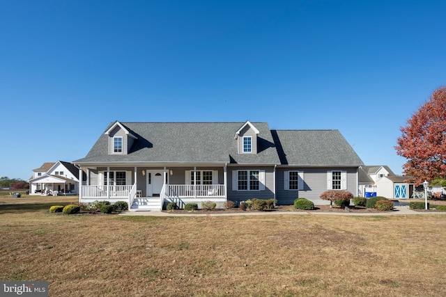 cape cod house featuring a porch and a front lawn