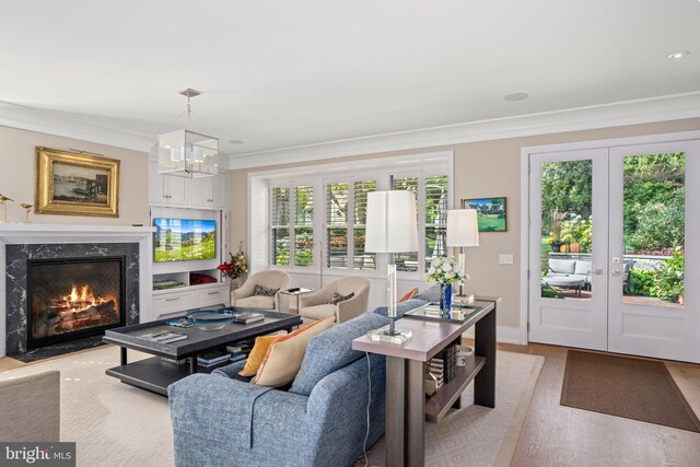 155 E Oakland Ave, Doylestown, PA 18901 - living area featuring french doors, crown molding, wood finished floors, a premium fireplace, and a chandelier