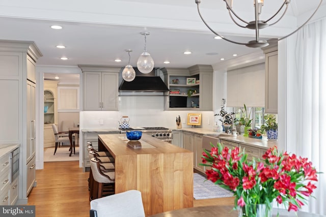 155 E Oakland Ave, Doylestown, PA 18901 - kitchen featuring premium range hood, stainless steel gas range oven, wood counters, a center island, and pendant lighting