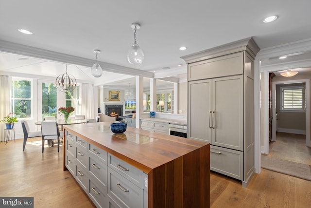 155 E Oakland Ave, Doylestown, PA 18901 - kitchen with wooden counters, gray cabinets, crown molding, paneled refrigerator, and pendant lighting